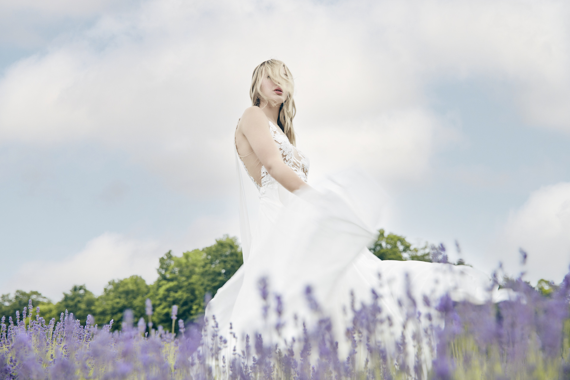 Lians' bridal editorial Hair & Makeup by Monica Jadan: a sun-kissed bride in a ruffled gown at Lavender Hills Farm, Michigan.