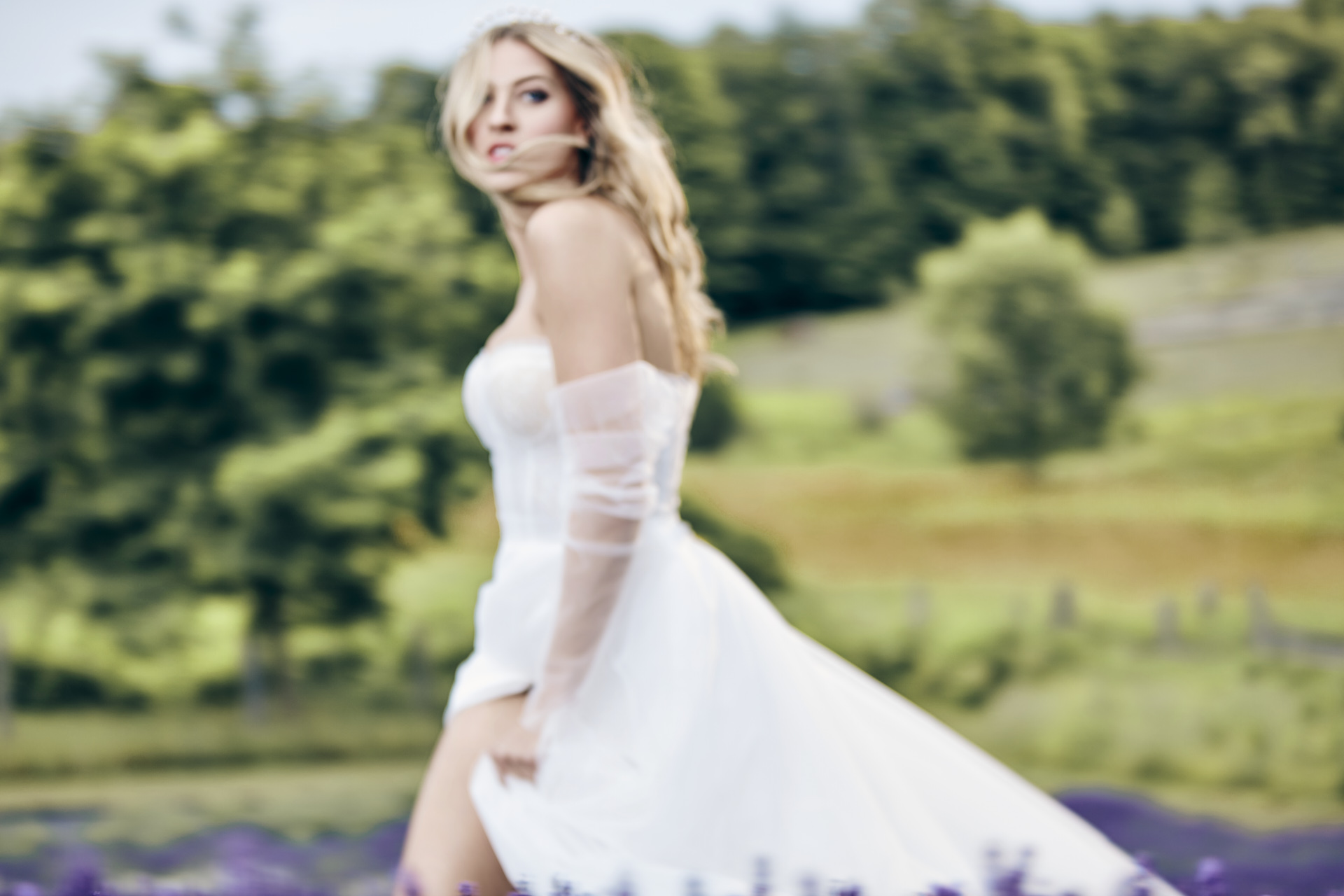 Lians' bridal editorial Hair & Makeup by Monica Jadan: a sun-kissed bride in a ruffled gown at Lavender Hills Farm, Michigan.