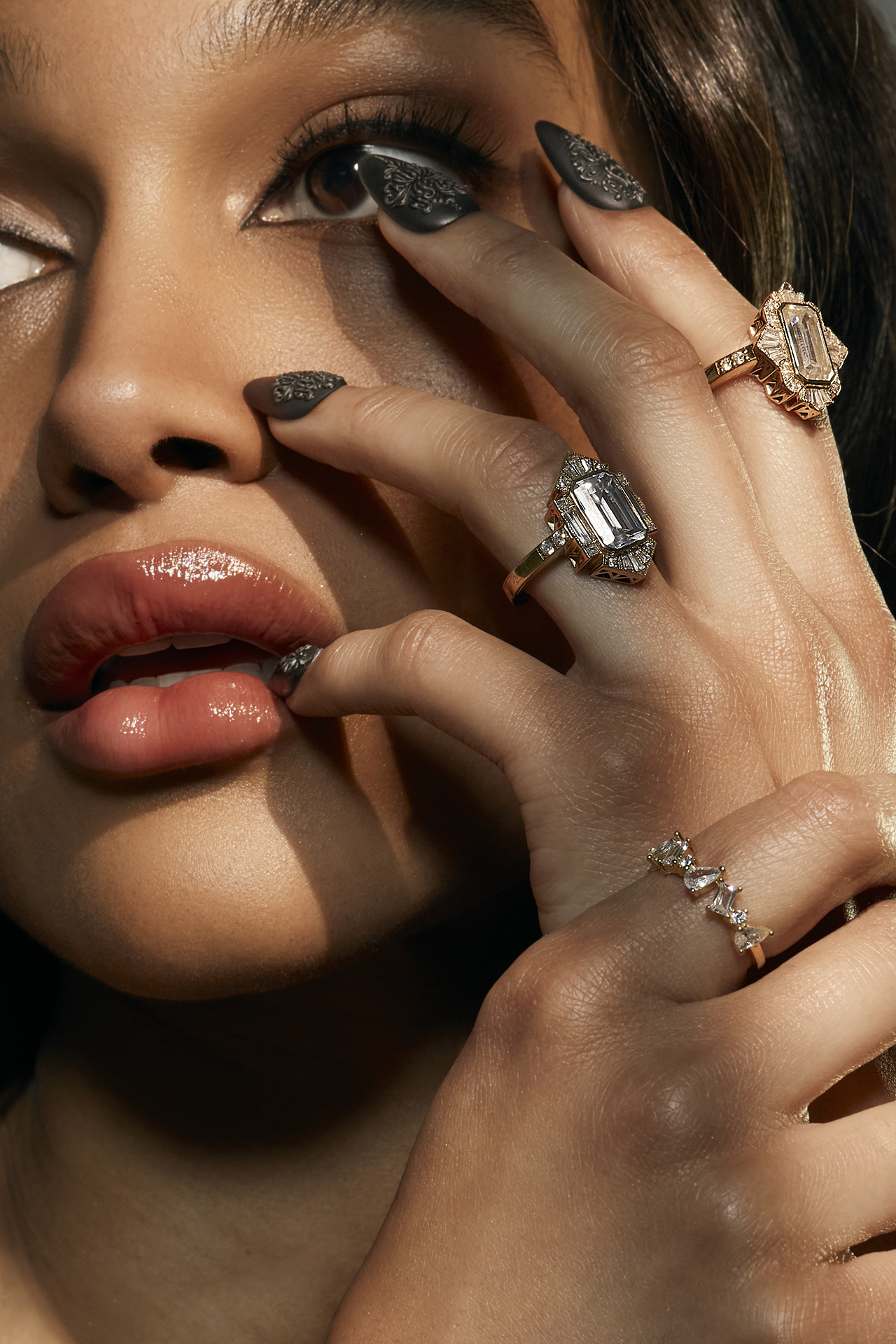 Dramatic close-up of Ahvonnah Viney covering one eye with bejeweled hands, accentuating the sparkle against her skin