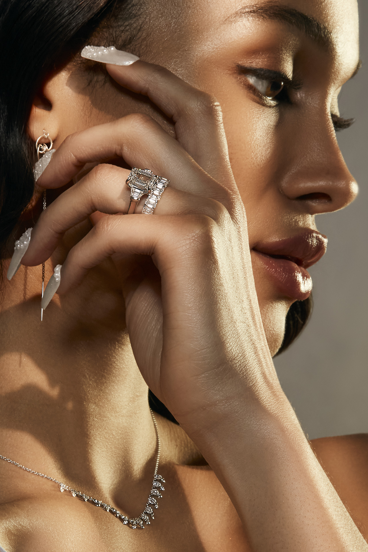 Profile shot of Ahvonnah Viney showcasing a delicate necklace and drop earrings amidst a serene expression, captured by Lians Jadan.
